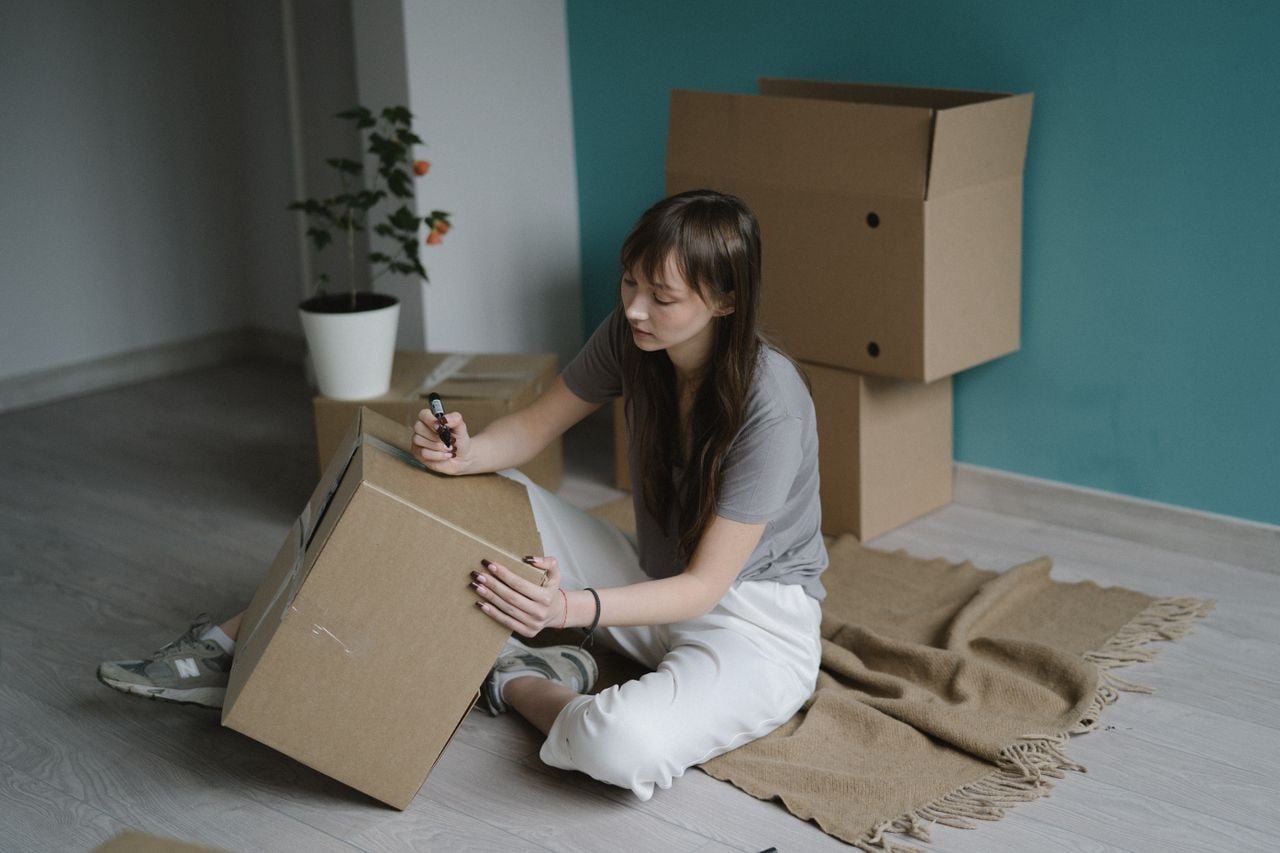 woman writing on box