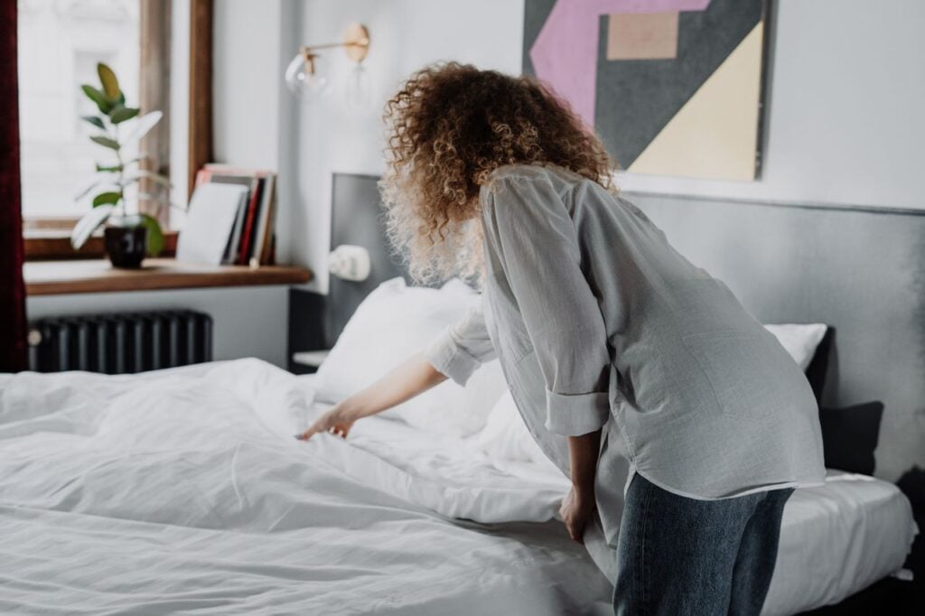 woman making bed