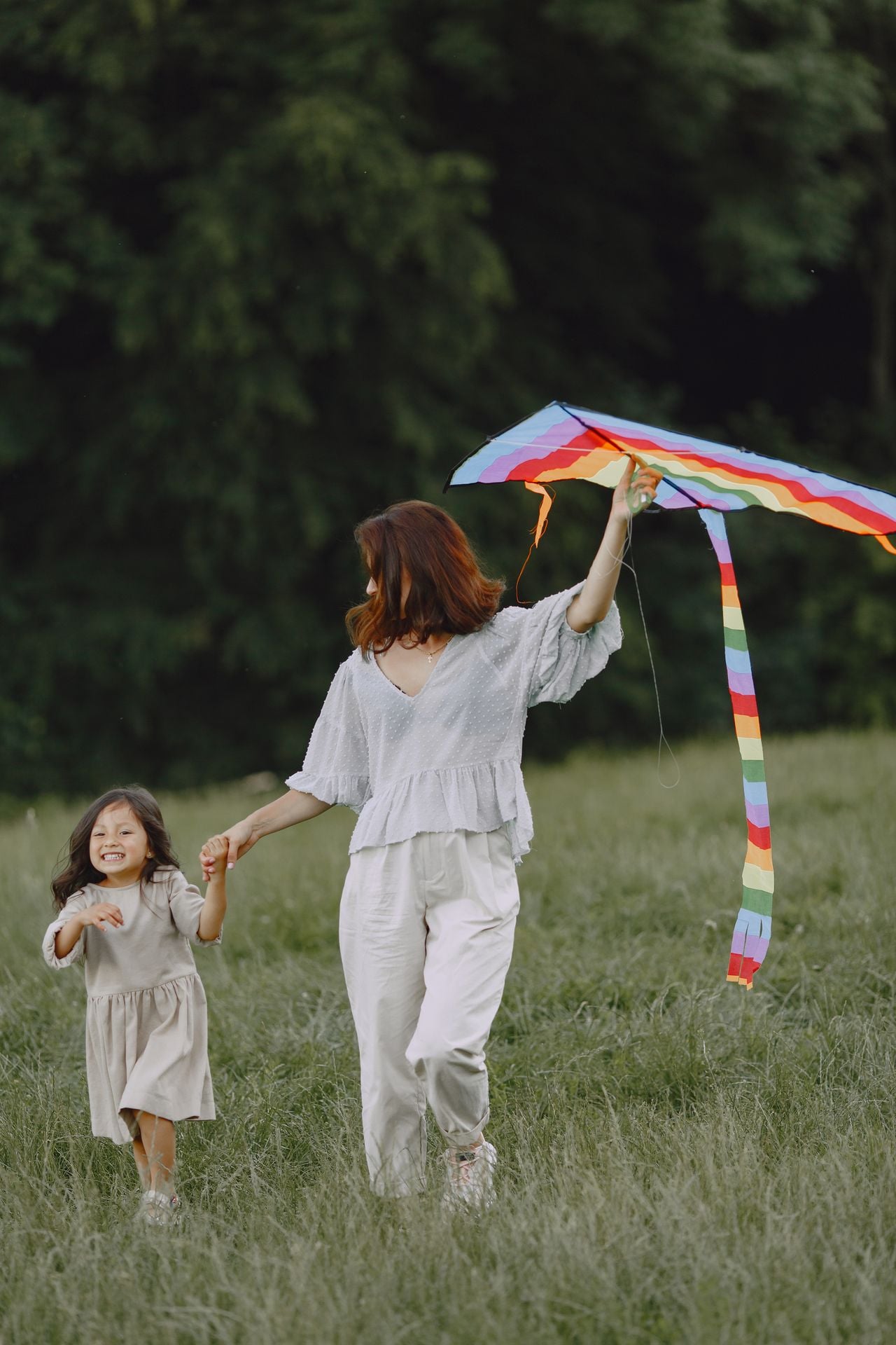 woman with her child flying a kite