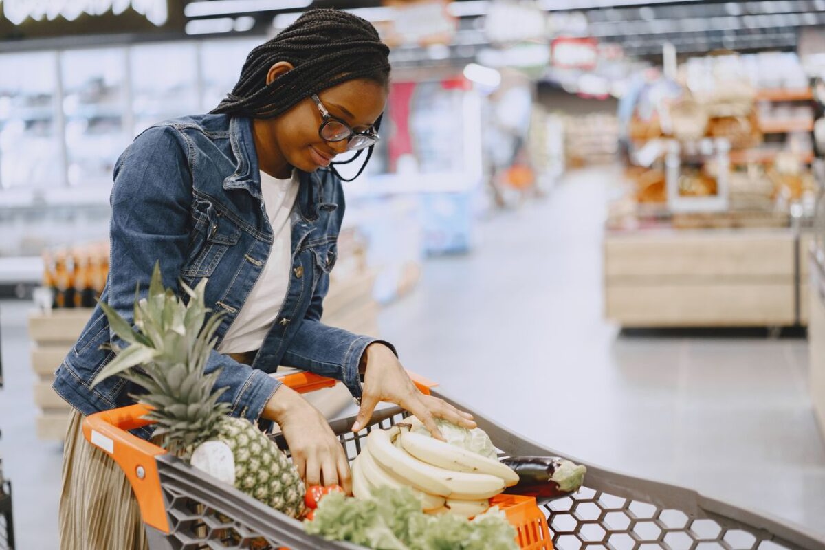 woman-looking-the-fruit-in-her-shopping-cart