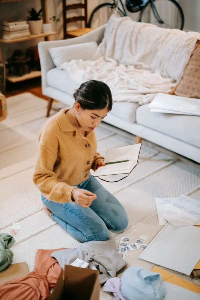 woman on floor decluttering