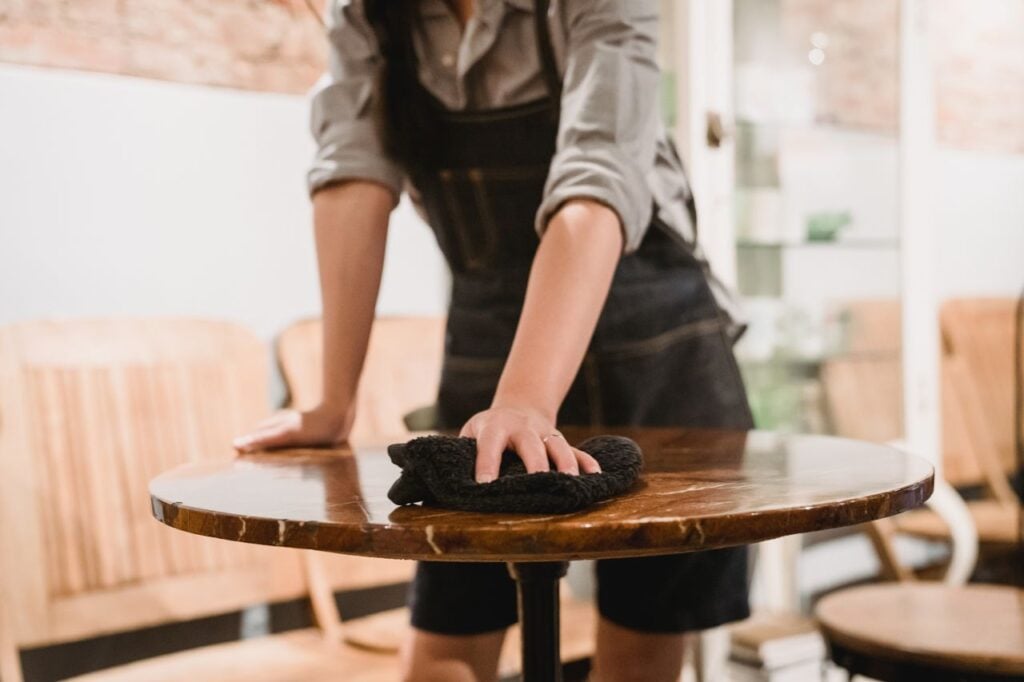 man cleaning furniture