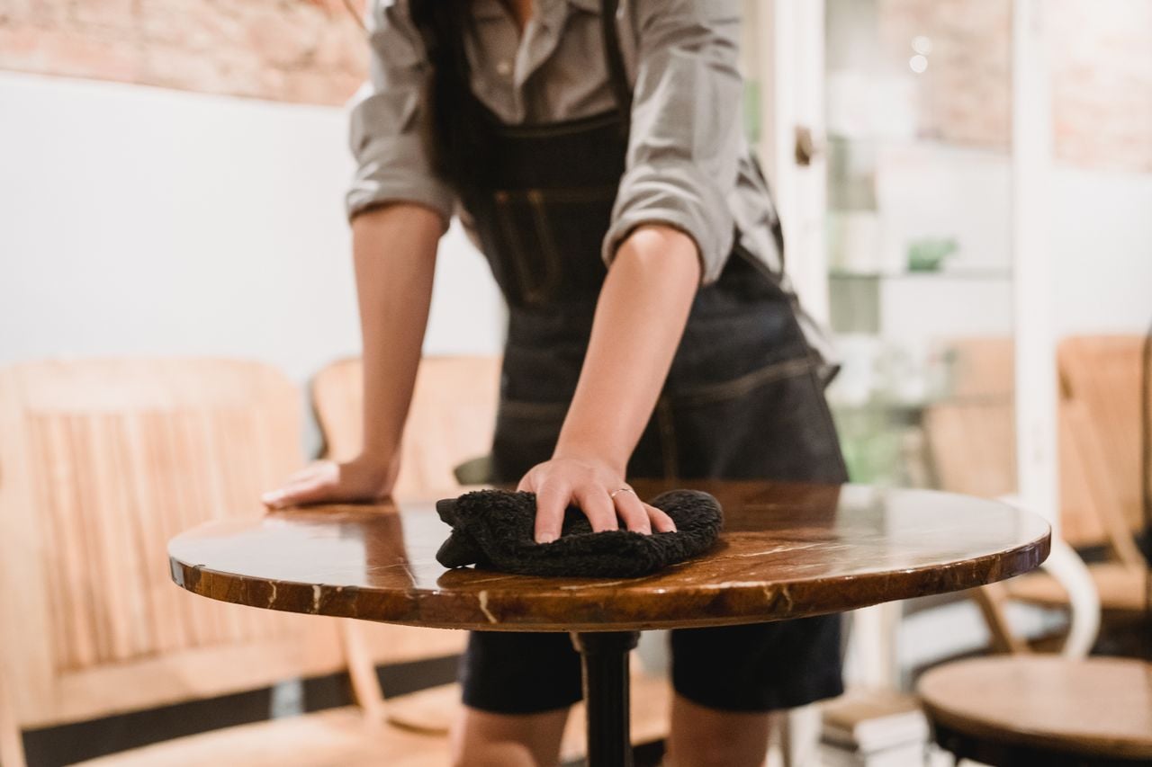 man cleaning furniture