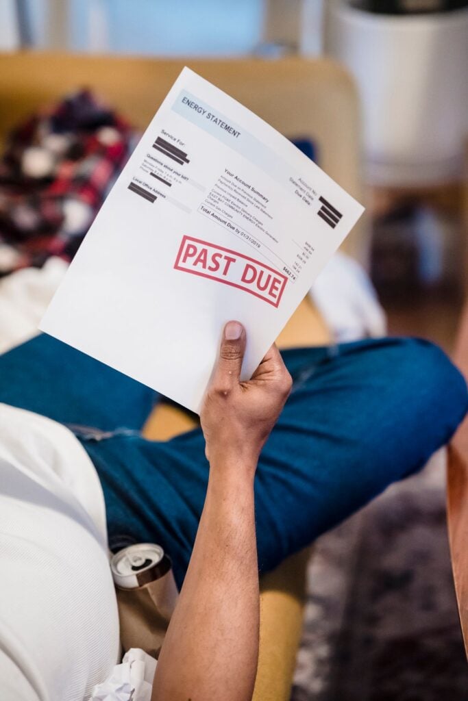 guy holding a past due bill