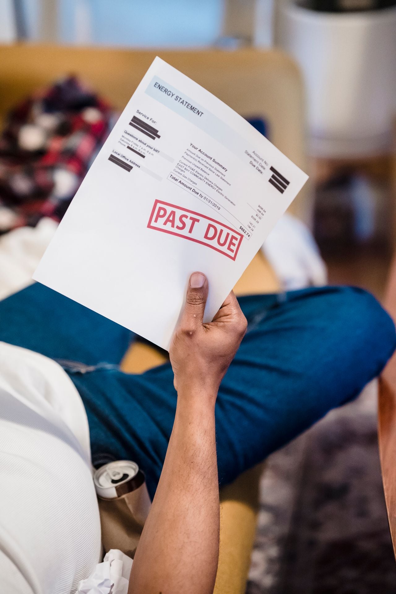 guy holding a past due bill