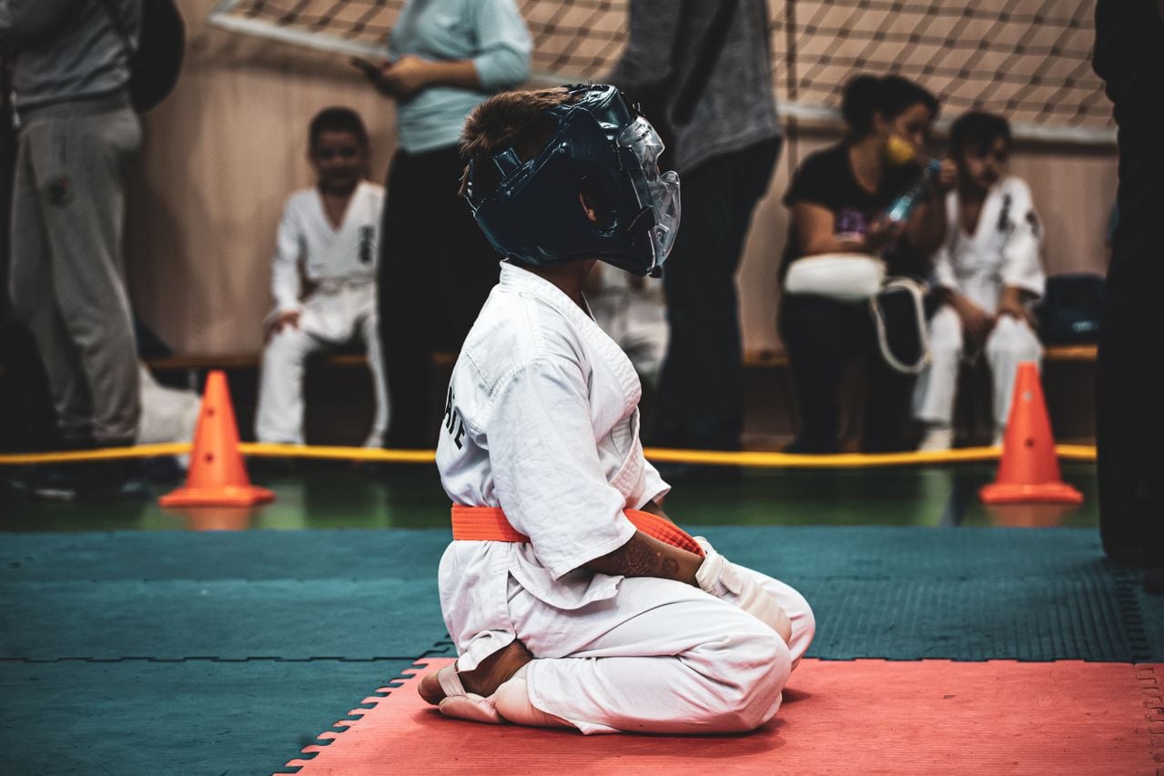 kid in karate outfit sports