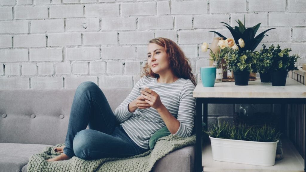 woman looking out in living room