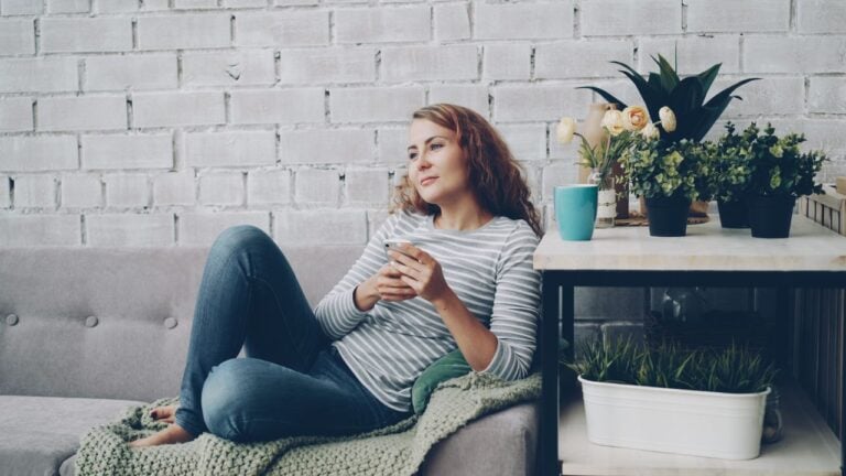 woman looking out in living room