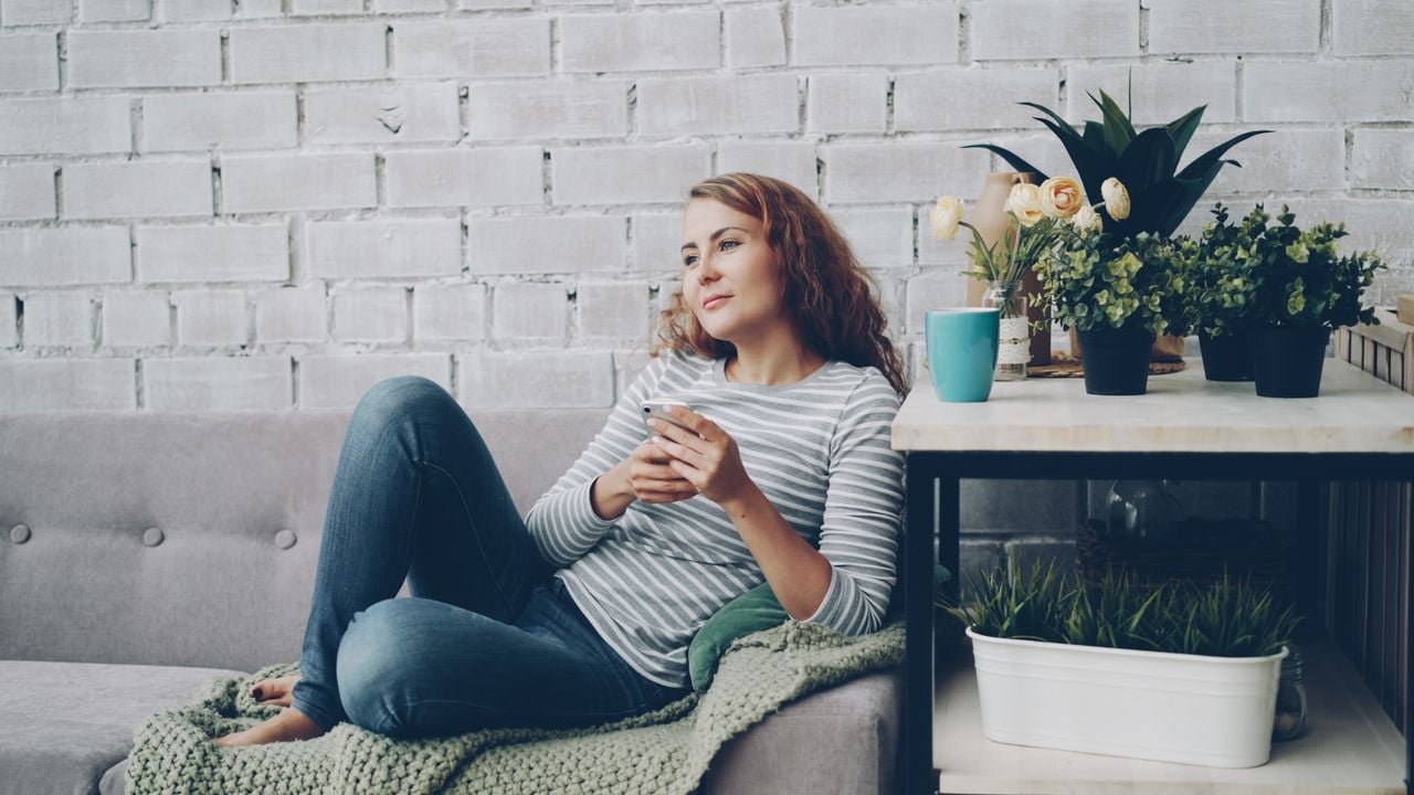 woman looking out in living room