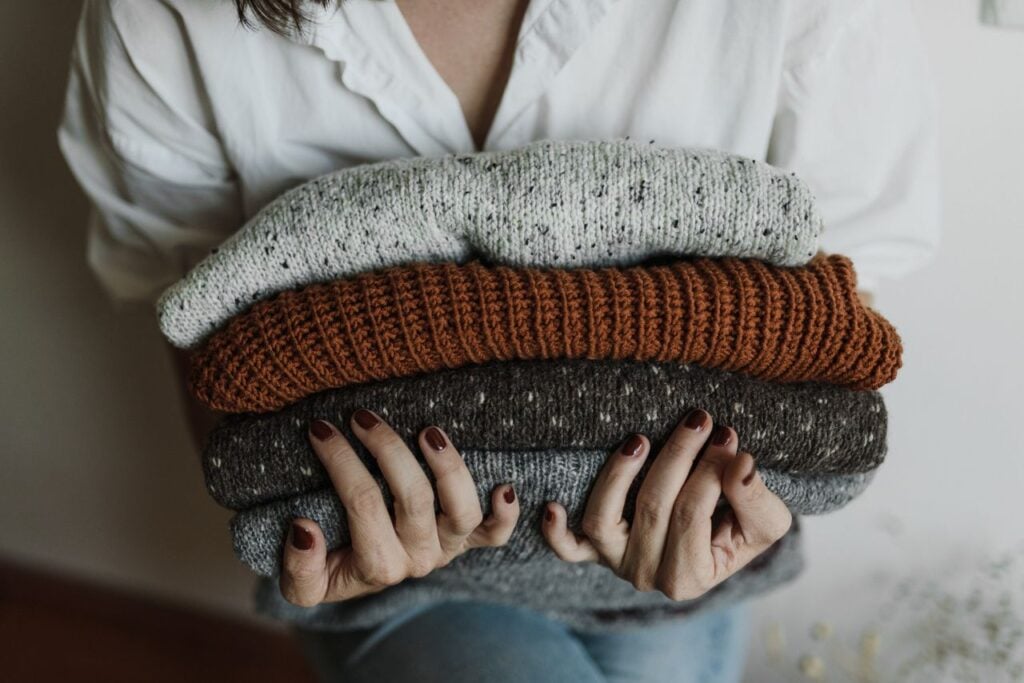 folded clothes in womans hand