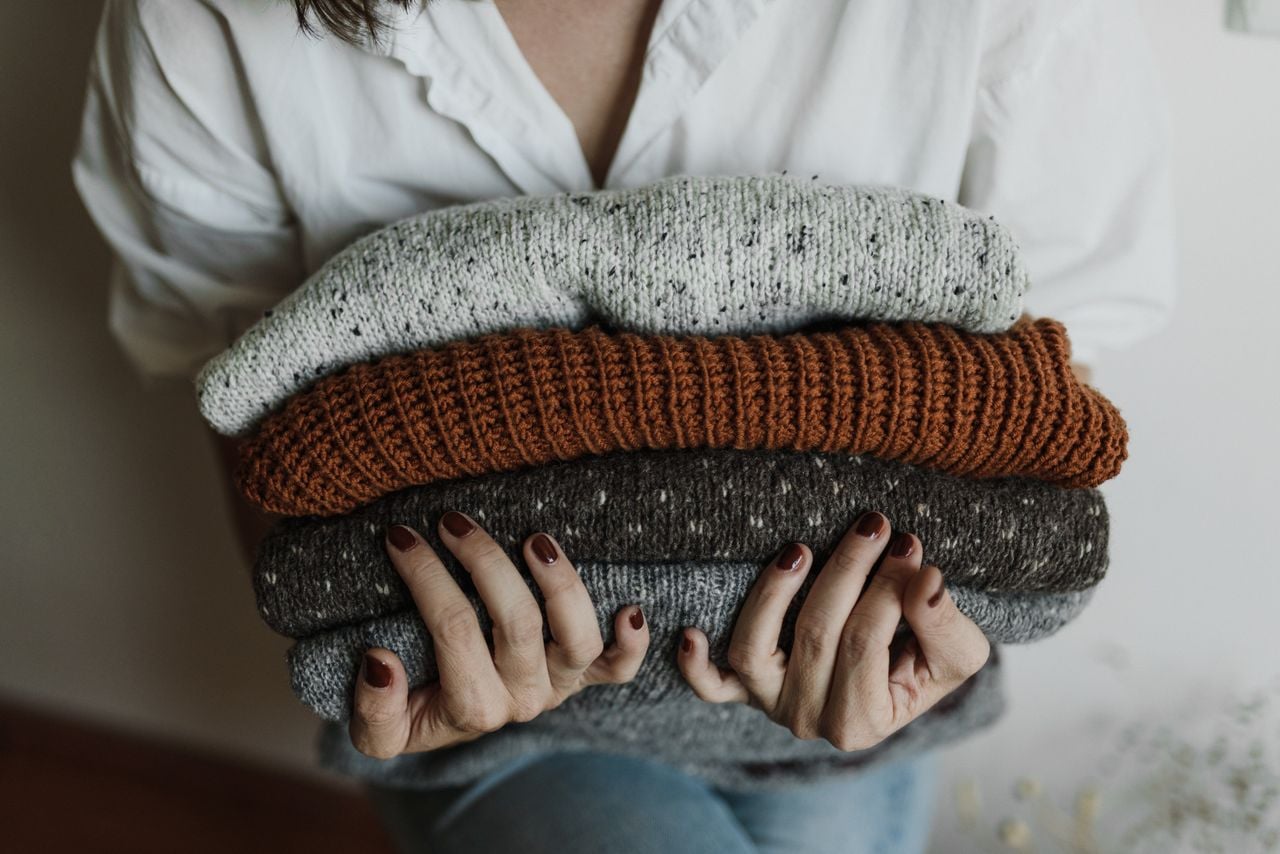 folded clothes in womans hand
