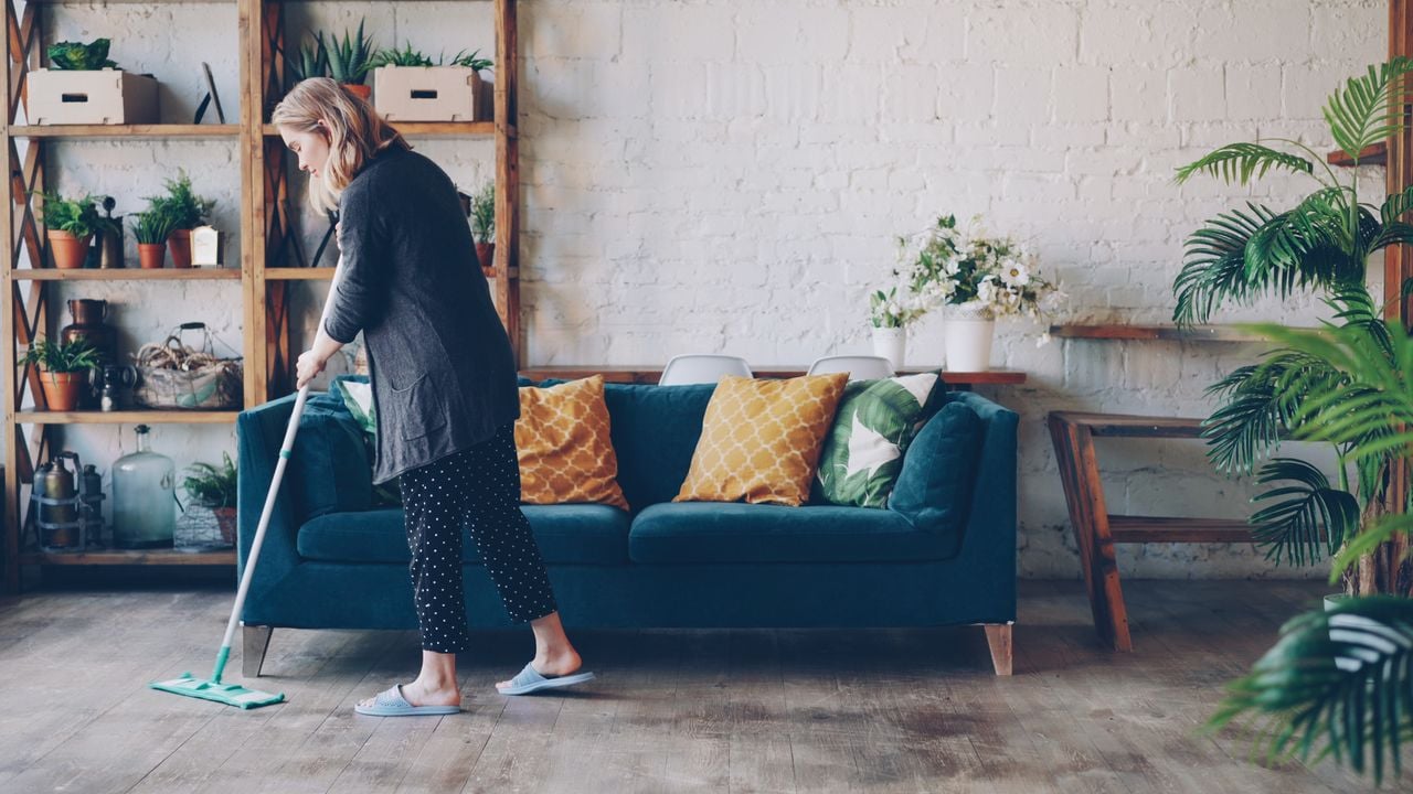 woman cleaning living room