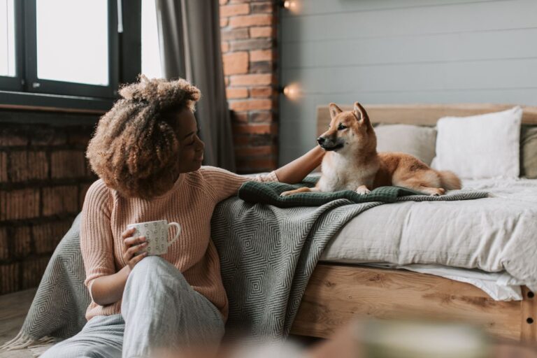 woman with dog on her bed