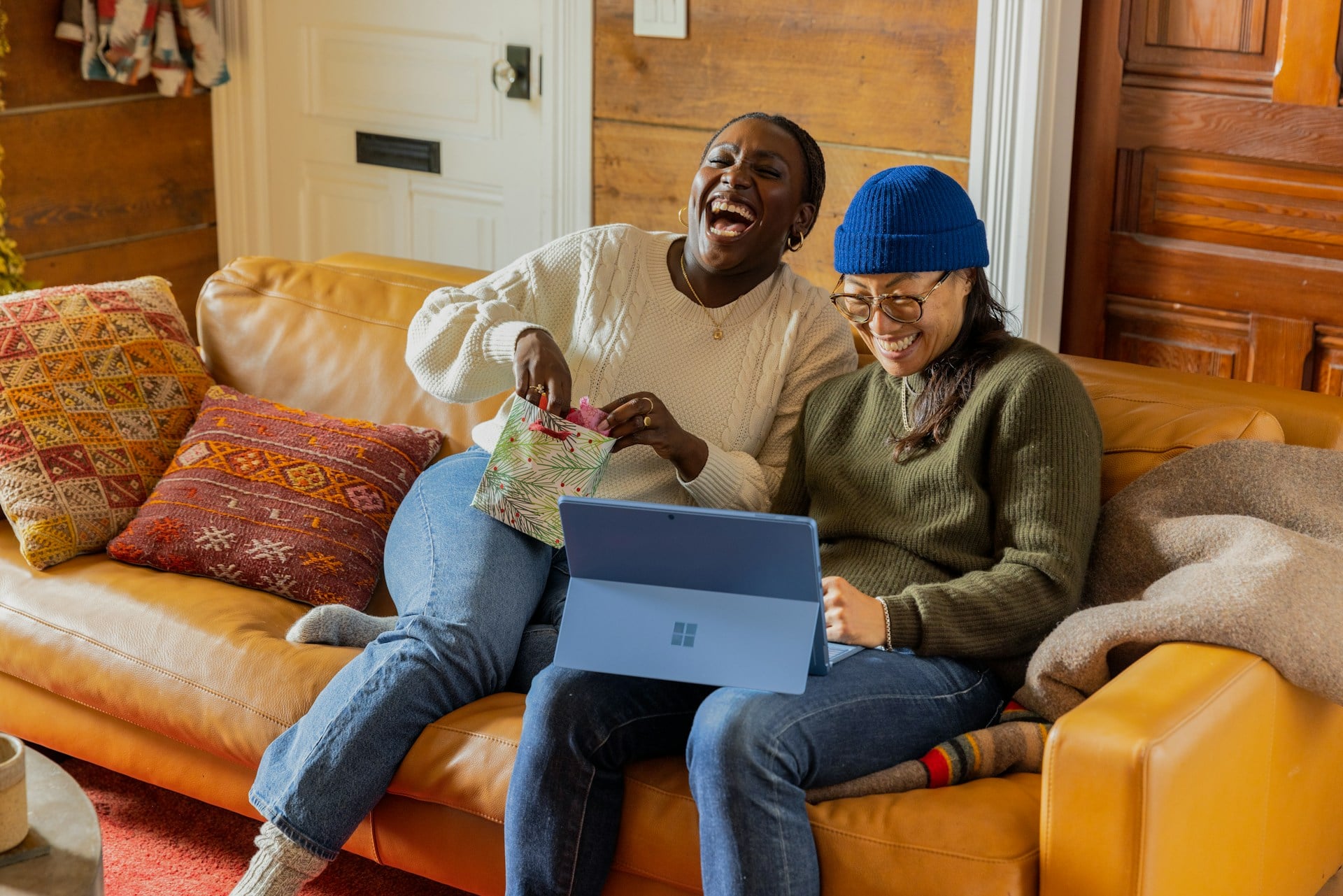two people laughing and surfing the net